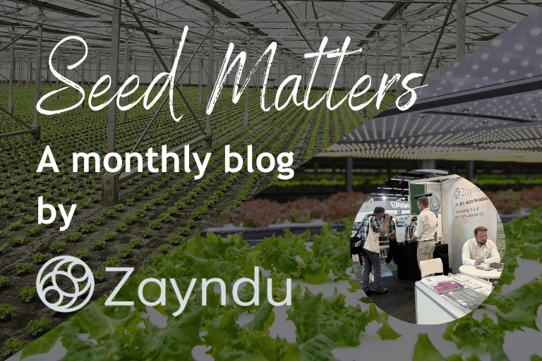 [blog image] Seed Matters: Another Successful Year of GreenTech: Showcasing the Best of AgriTech. [image of two team members talking to GreenTech attendees. One of the attendees in taking a picture of the Z25 machine].